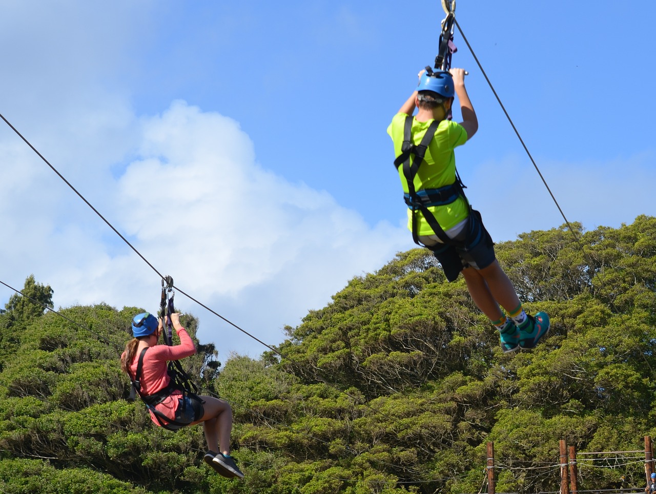 Two people using a Zipline in Hawaii