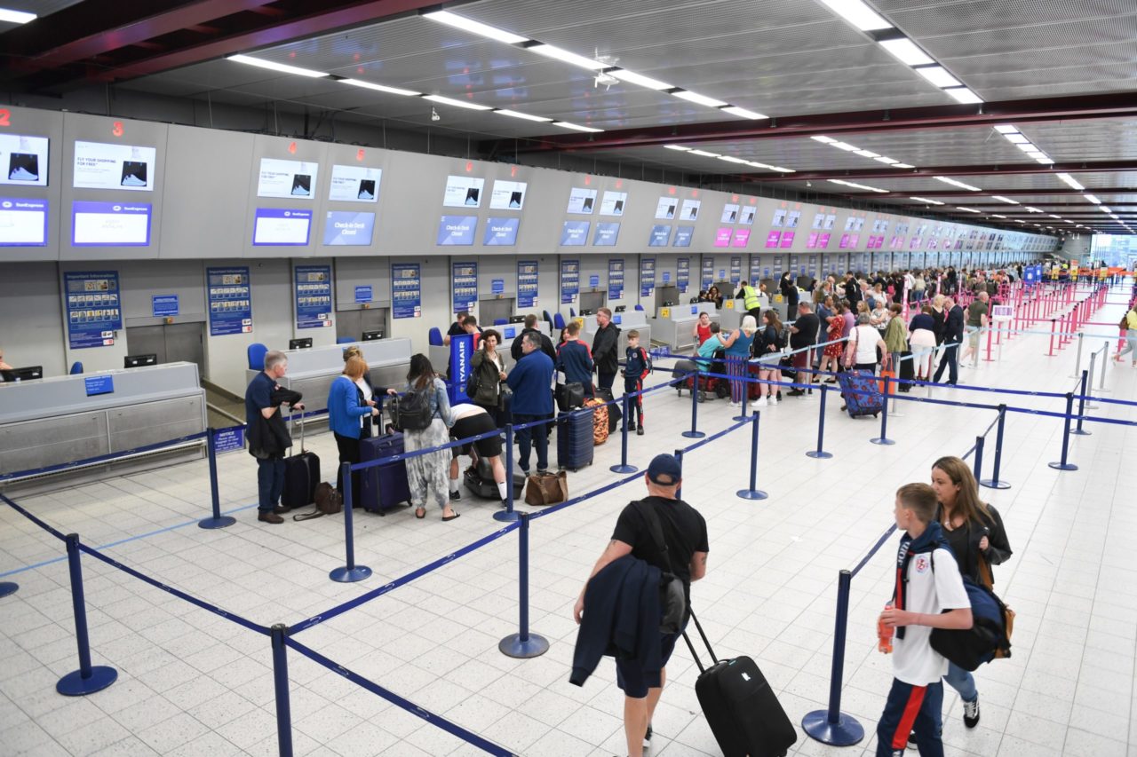 Airport Terminal with People Getting into Line