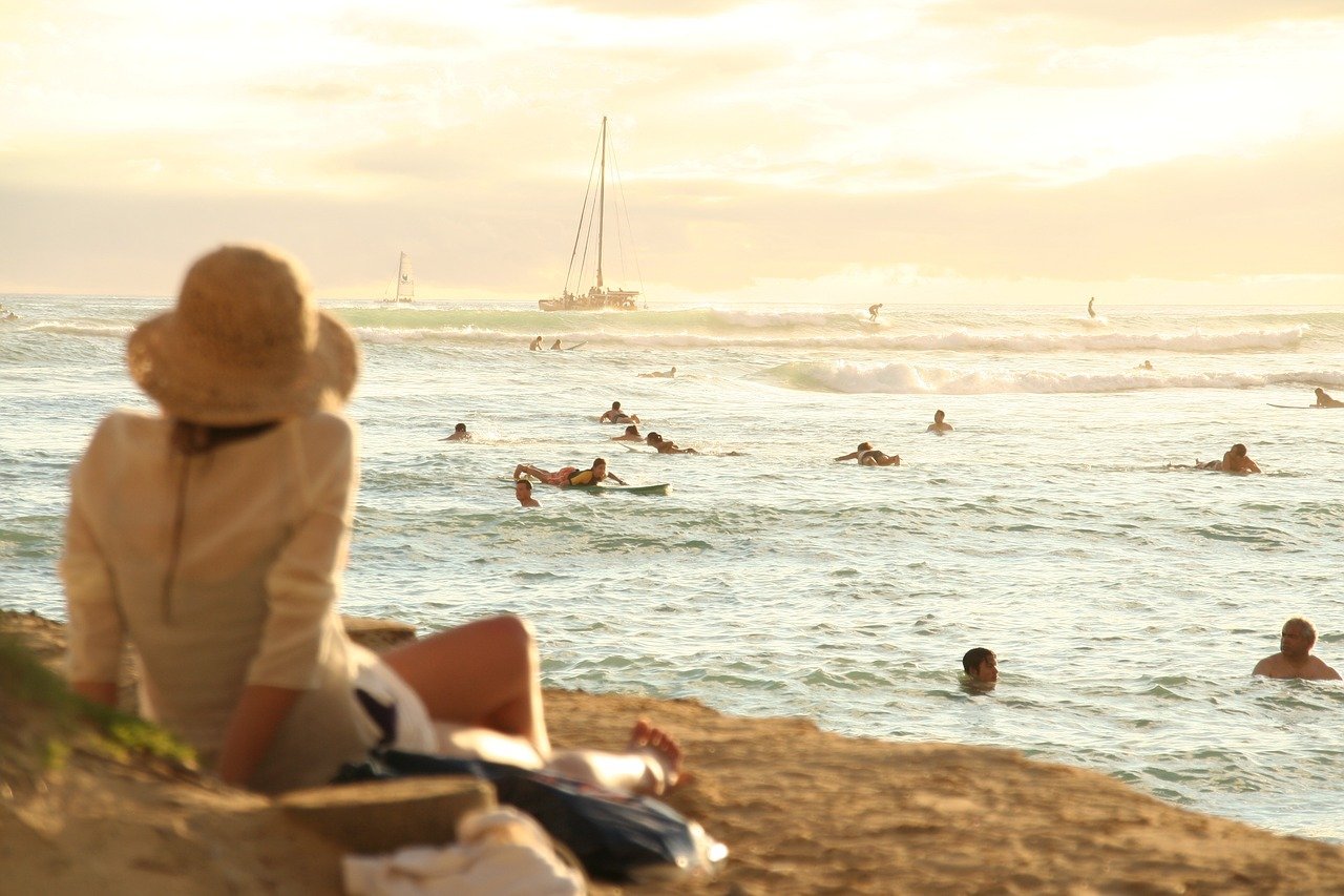 A Woman Enjoying the Beach in Front of our Hawaii Holiday Rentals.