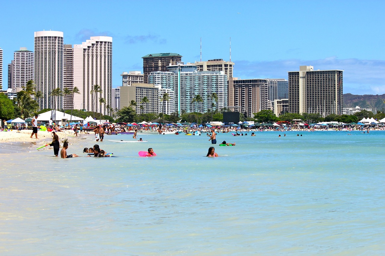 People in the ocean by many Oahu resorts