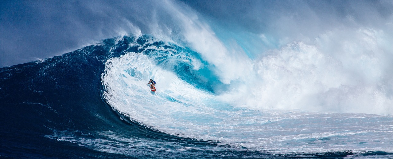 A man surfing inside a giant wave