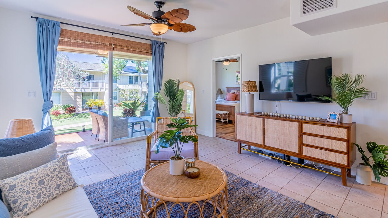 The living area of an Oahu Island vacation rental with door open to the outside