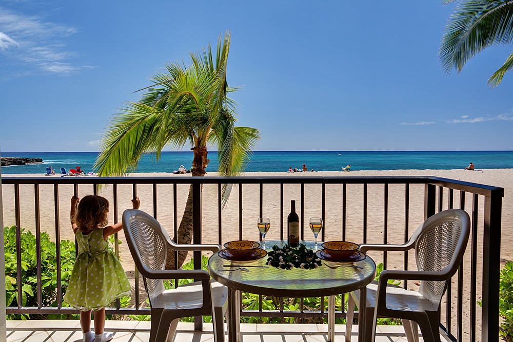 A child grabbing the bars of a patio of one of our 2 bedroom condos for rent in Oahu Hawaii